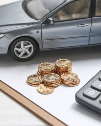 car model,calculator and coins on white table