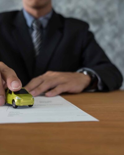 transportation and ownership concept - customer and salesman with car key
