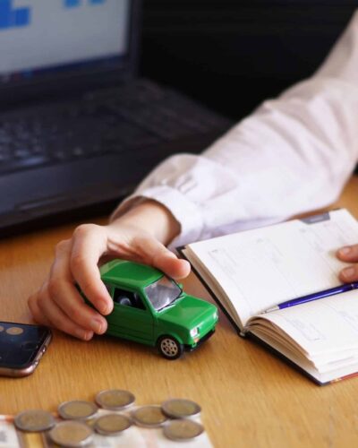A closeup shot of a person thinking of buying a new car or selling a vehicle
