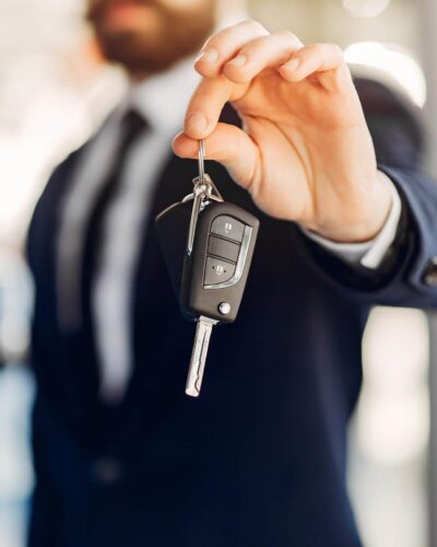 Man buying the car. Businessman in a car salon
